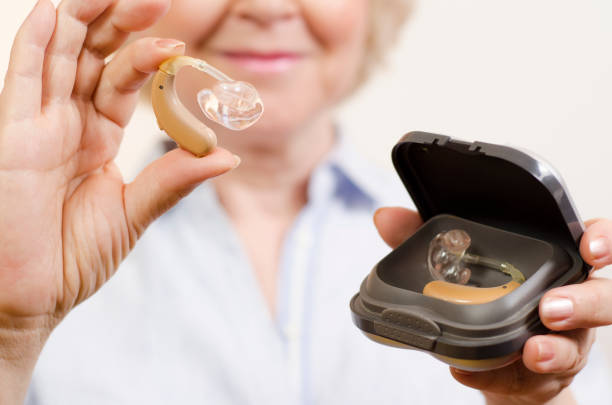 closeup shot of unrecognizable senior woman holding hearing aids